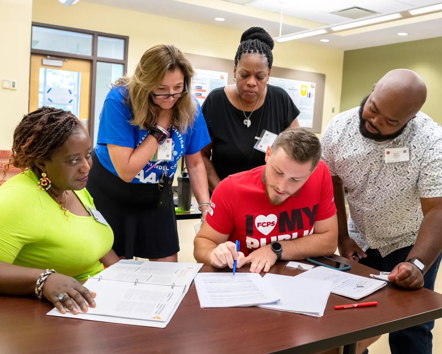 edcuators review a contract over a table