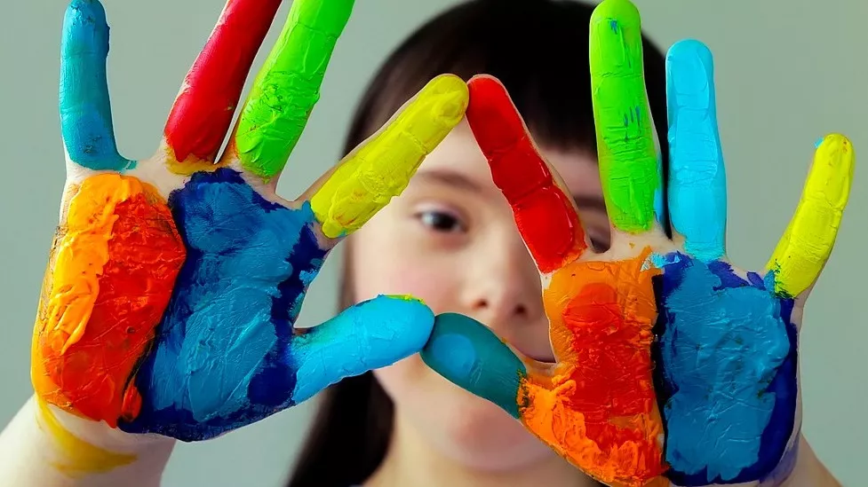 Student with paint on hands