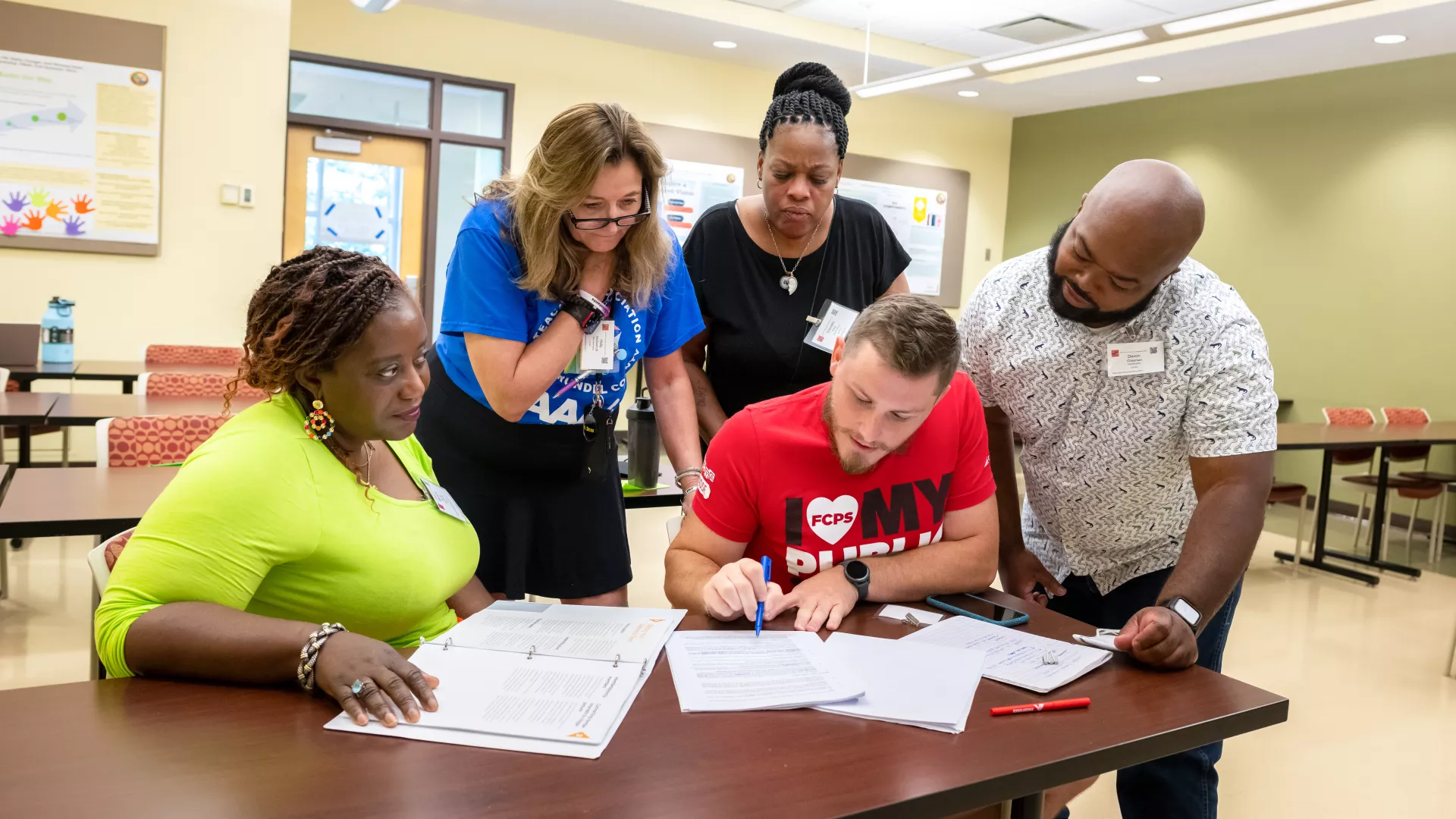 edcuators review a contract over a table