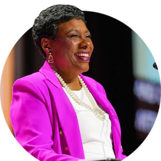 NEA President stands at a lectern and delivers her 2023 keynote address at the NEA RA in Orlando