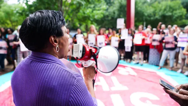 Becky Pringle at an immigration rally with a bullhorn
